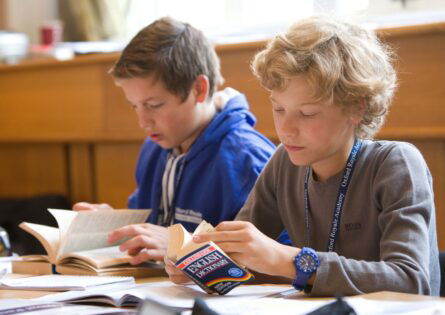 boys reading dictionary in class