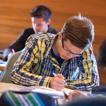 boy writing in class