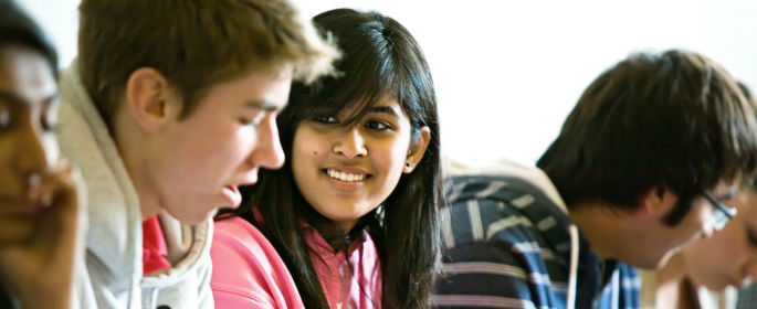 Image shows a drop of students in discussion. 