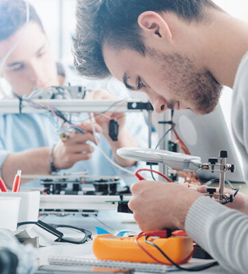 Students wiring components - Engineering summer school